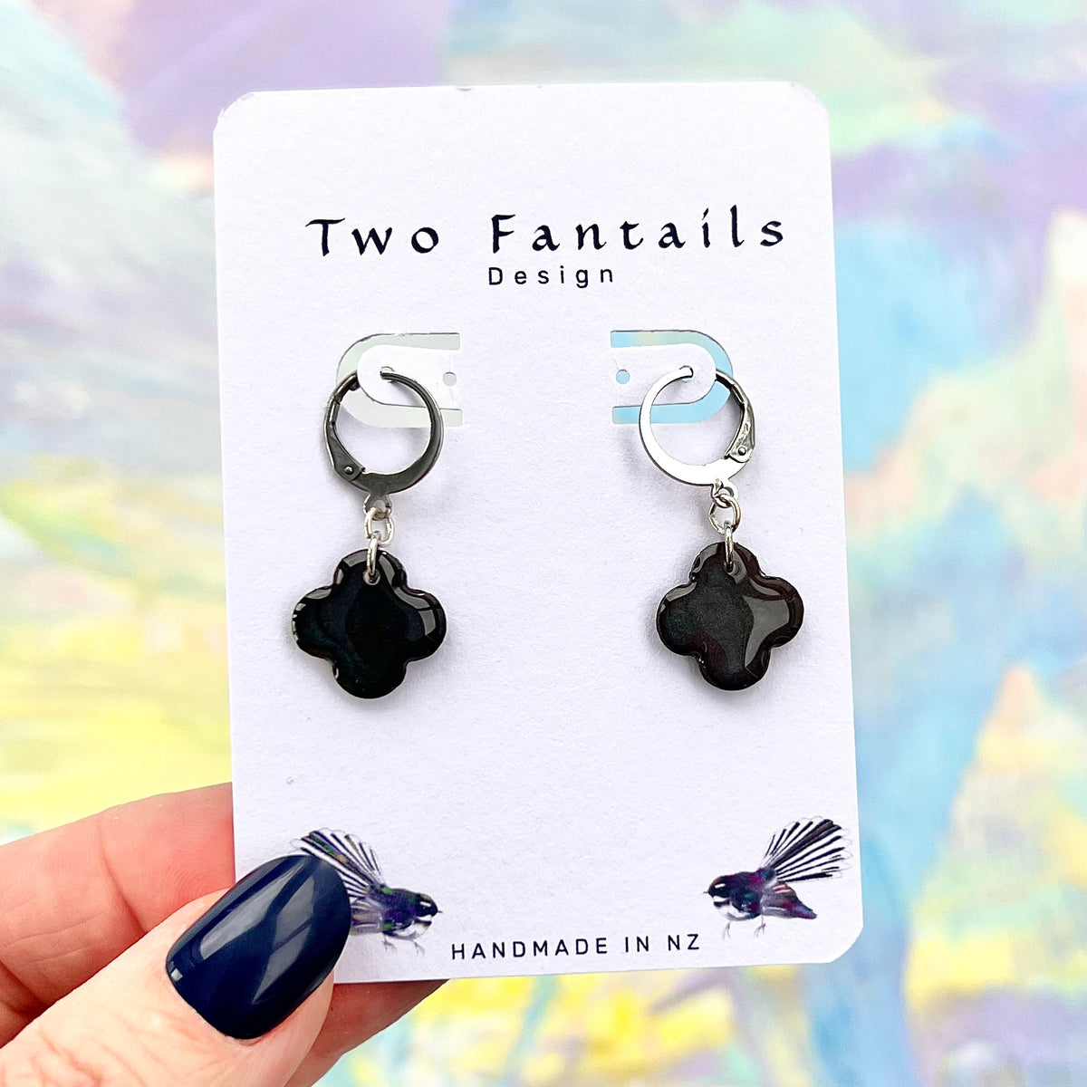 Glossy black clover-shaped drop earrings with silver-tone huggie hoops