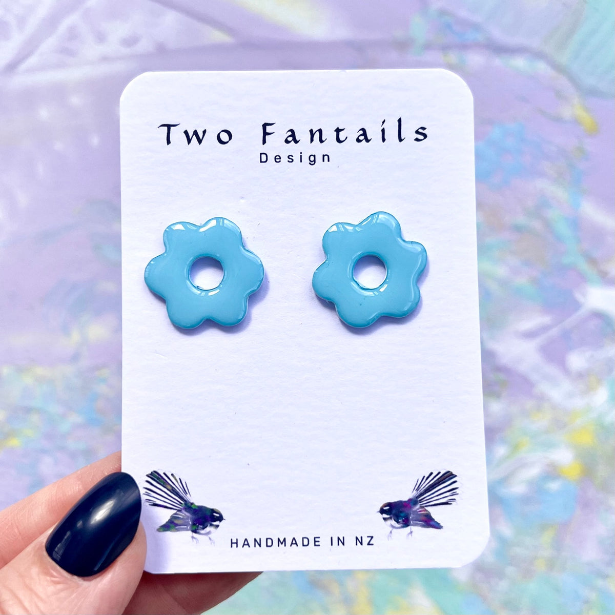Glossy sky blue flower stud earrings with open centres
