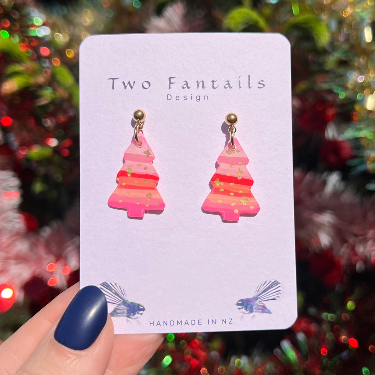 Pink Christmas tree earrings with bright coral stripes and delicate gold flecks, finished with gold-tone ball studs
