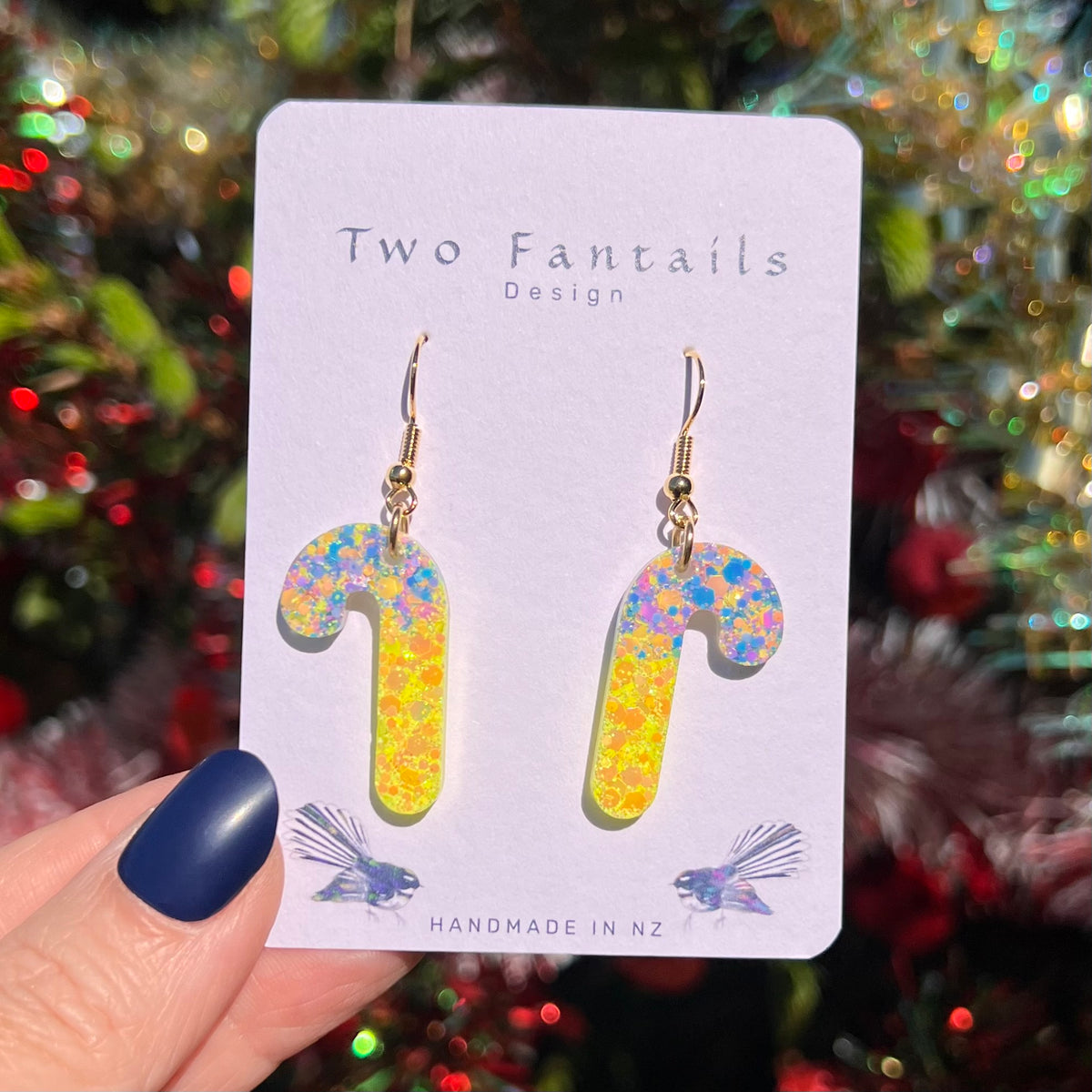Rainbow pastel confetti candy canes fading into bright sunshine yellow glitter with gold-tone hooks