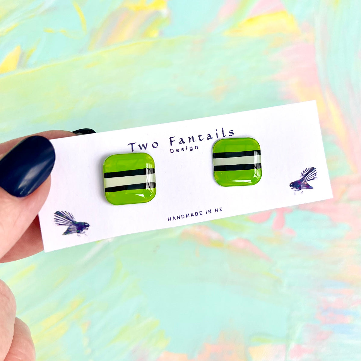Lime green square stud earrings with black and cream licorice allsort stripes
