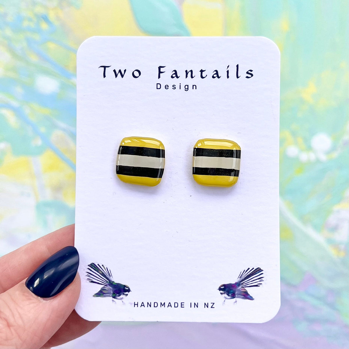 Second hand-painted pair of Licorice Allsort Yellow square studs, with slightly different stripe placement