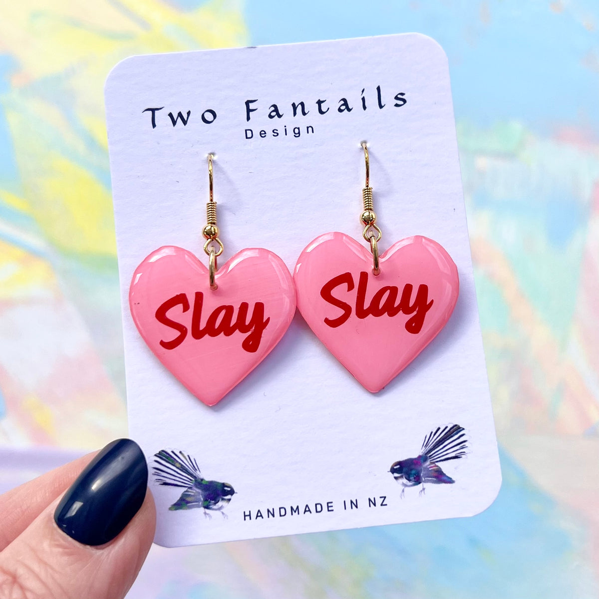 Pink heart earrings with red Slay lettering and gold-tone hooks