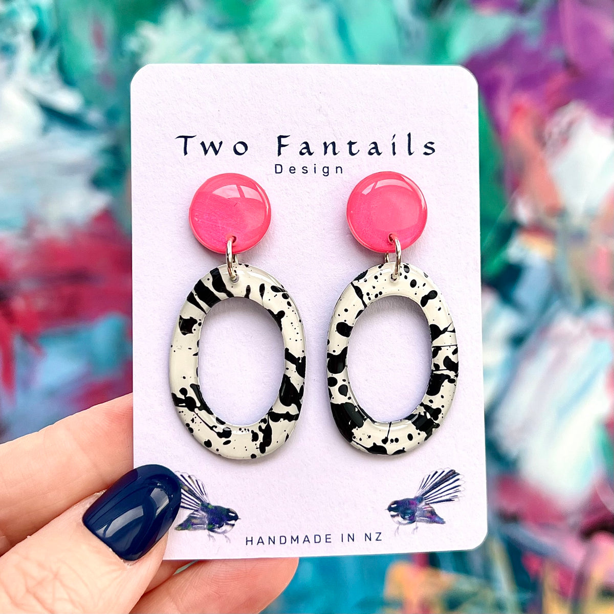 Pretty in Punk hot pink stud earrings with black splatter patterned white open oval drops