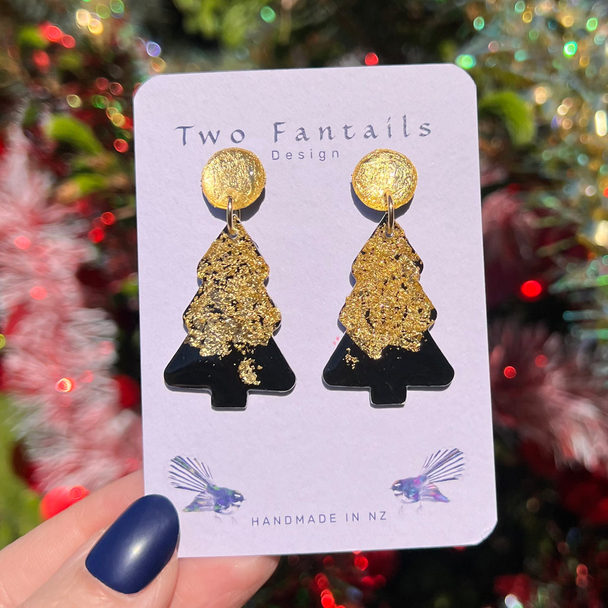 Glossy black Christmas trees decorated with textured gold shimmer and matching gold round studs