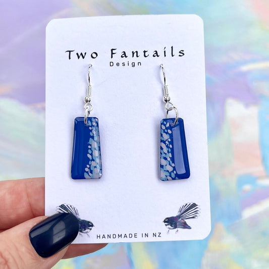Cobalt blue trapezoid earrings with pale blue and white dot detailing and silver-tone hooks