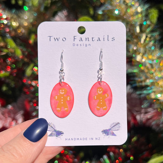 Pink shimmer oval drops with smiling gingerbread figures