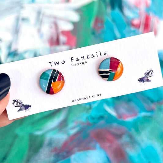 Glossy round hand-painted stud earrings with turquoise teal orange burgundy and black abstract colour blocks