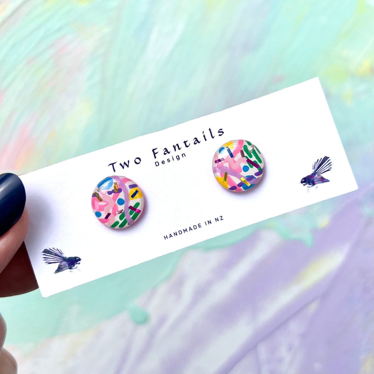 Colourful hand painted round stud earrings with pink, blue, green, yellow and purple abstract confetti marks