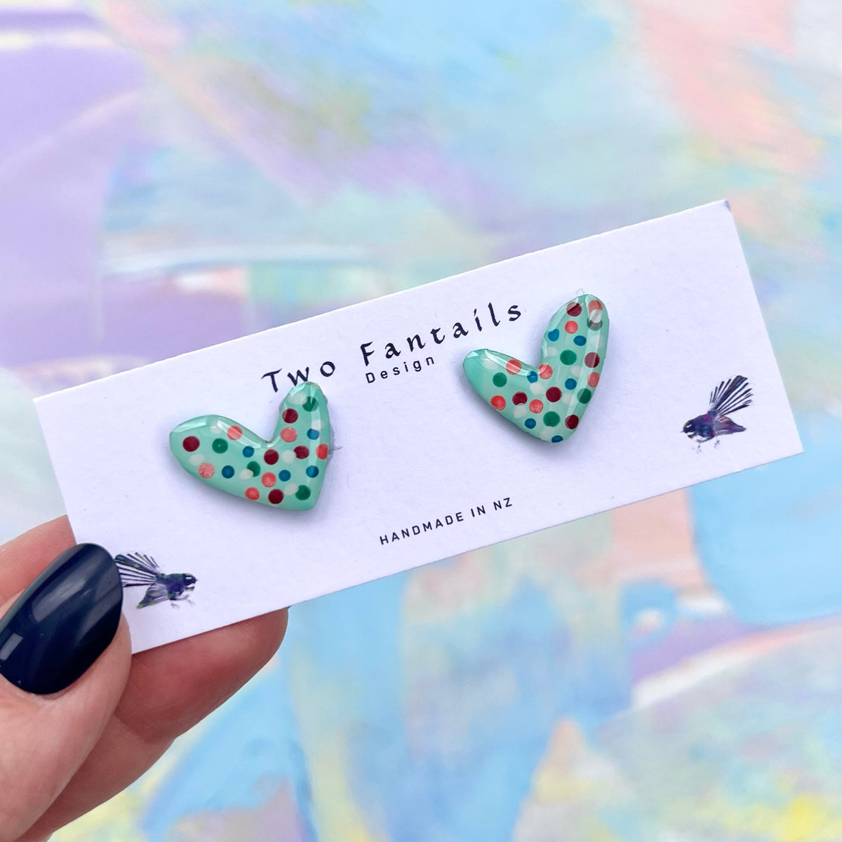 Mint green heart shaped stud earrings with colourful pink red teal and blue handpainted polka dots
