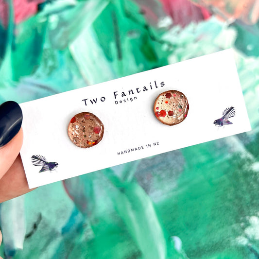 Handmade round copper and rose gold glitter stud earrings with red and silver confetti flecks