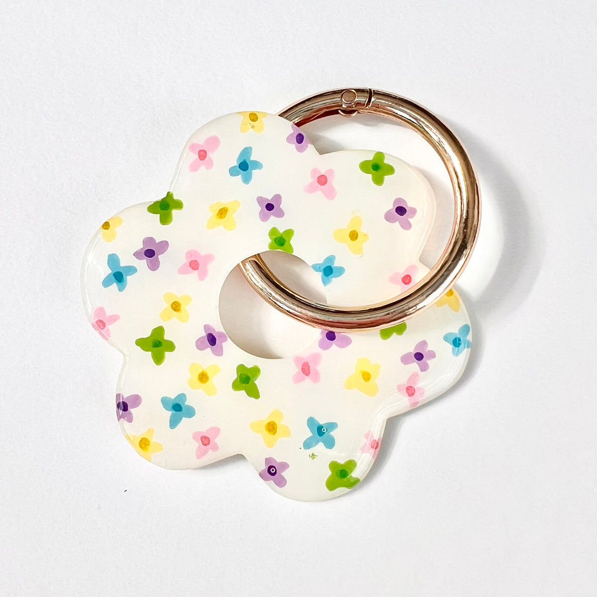 White flower-shaped chunky keyring with tiny colourful flowers