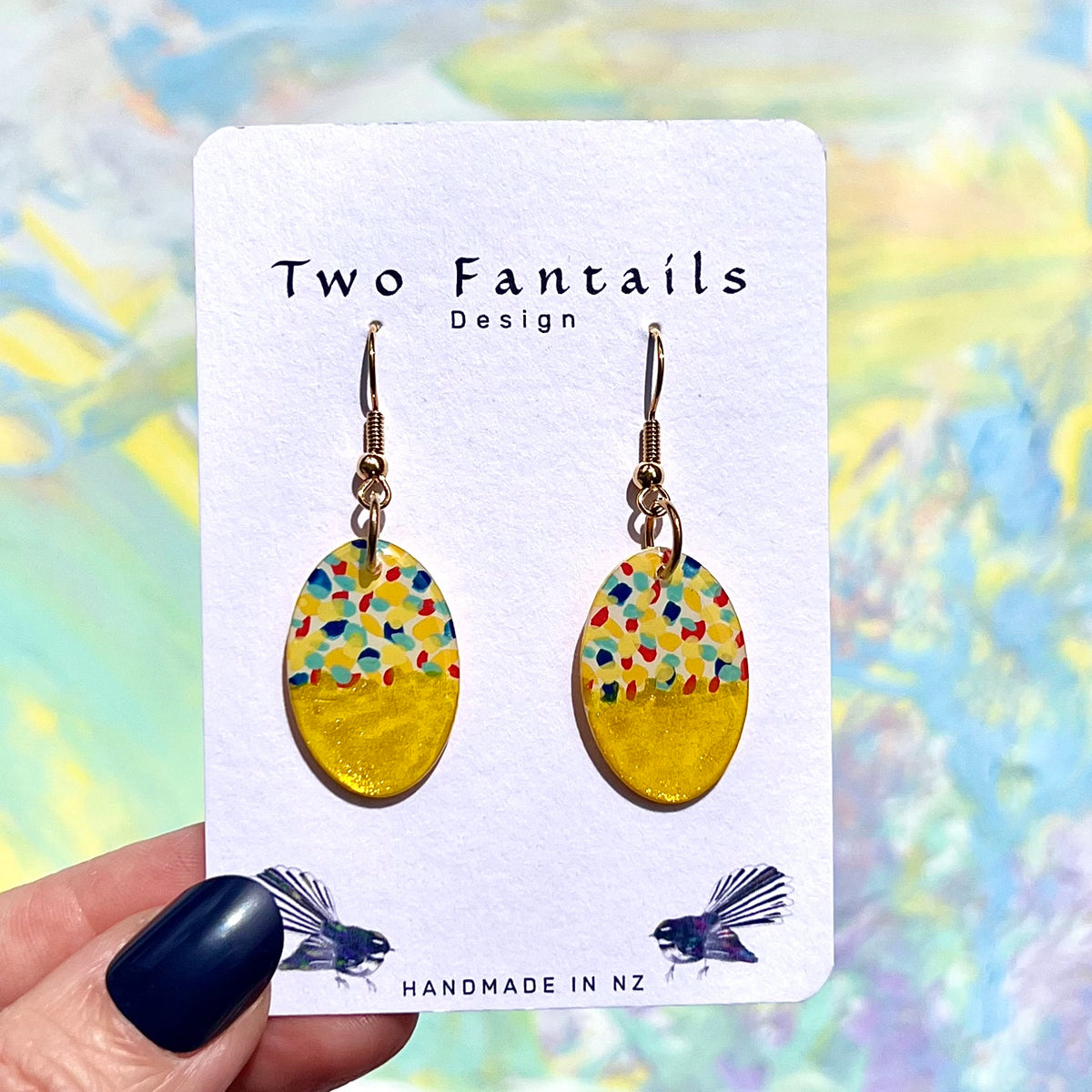 Colourful confetti-patterned oval dangle earrings with shimmering gold-yellow lower halves
