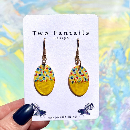 Colourful confetti-patterned oval dangle earrings with shimmering gold-yellow lower halves