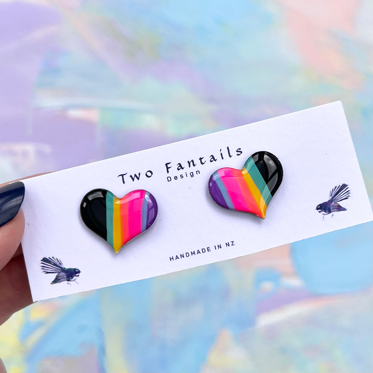 Hand-painted heart shaped stud earrings with glossy black teal yellow pink and purple colour block stripes