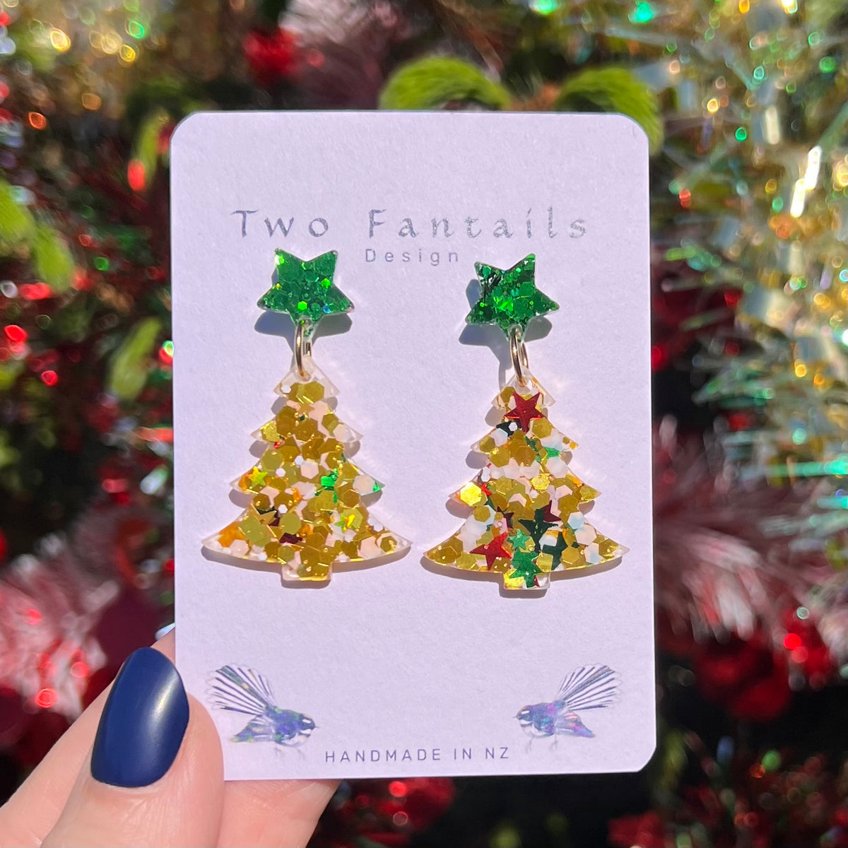 Sparkling green star studs and clear Christmas trees filled with gold confetti and colourful stars