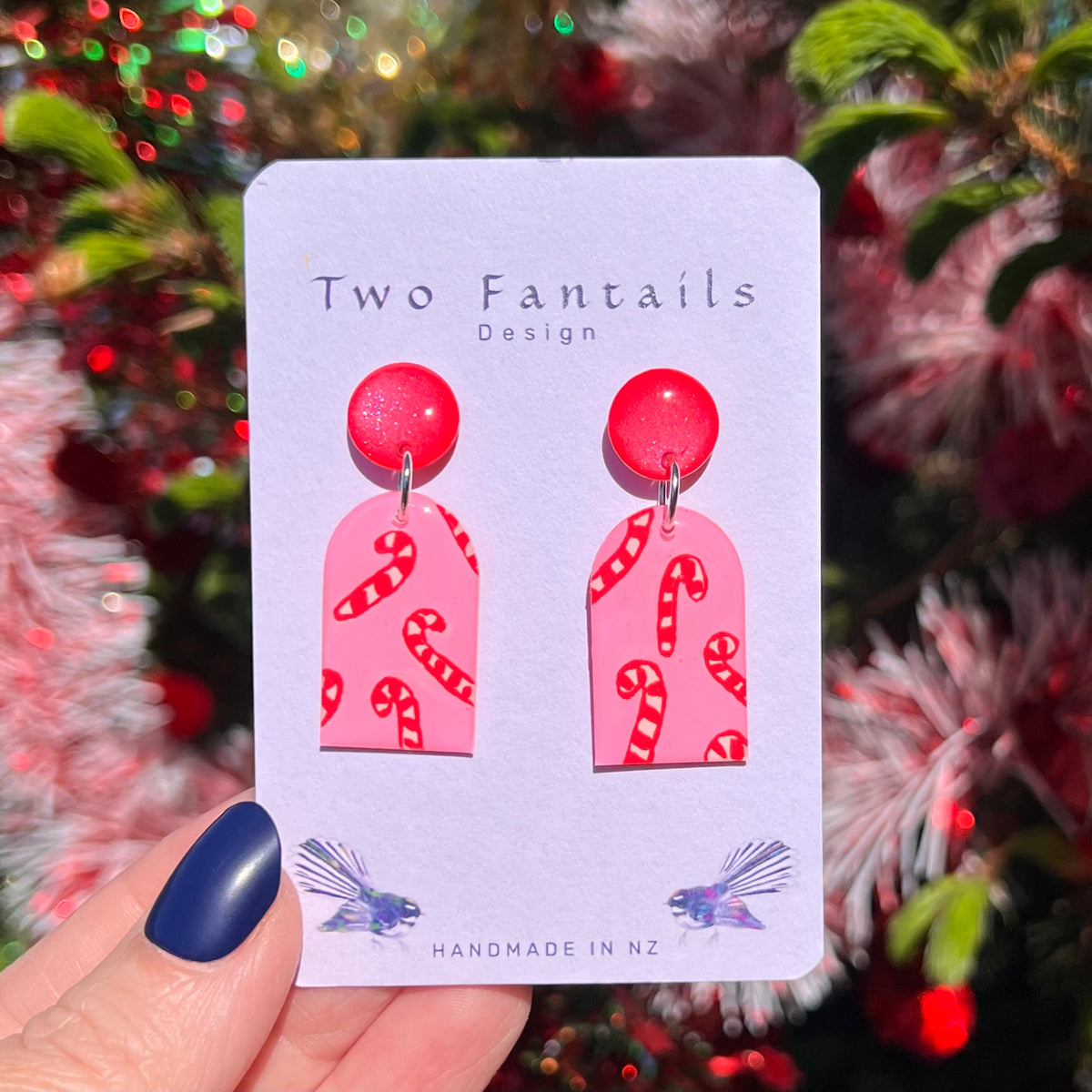 Soft pink arch drops hand-painted with little red candy canes, hanging from vibrant pink shimmer studs