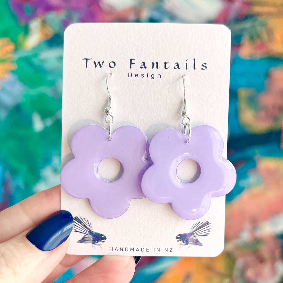 Pastel lilac purple glossy five petal flower shaped dangle earrings with circular cutouts and silver-tone hooks by Two Fantails Design
