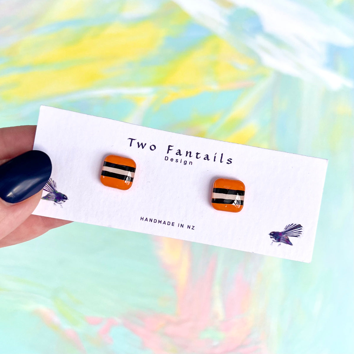 Mini orange square stud earrings with licorice allsort stripes
