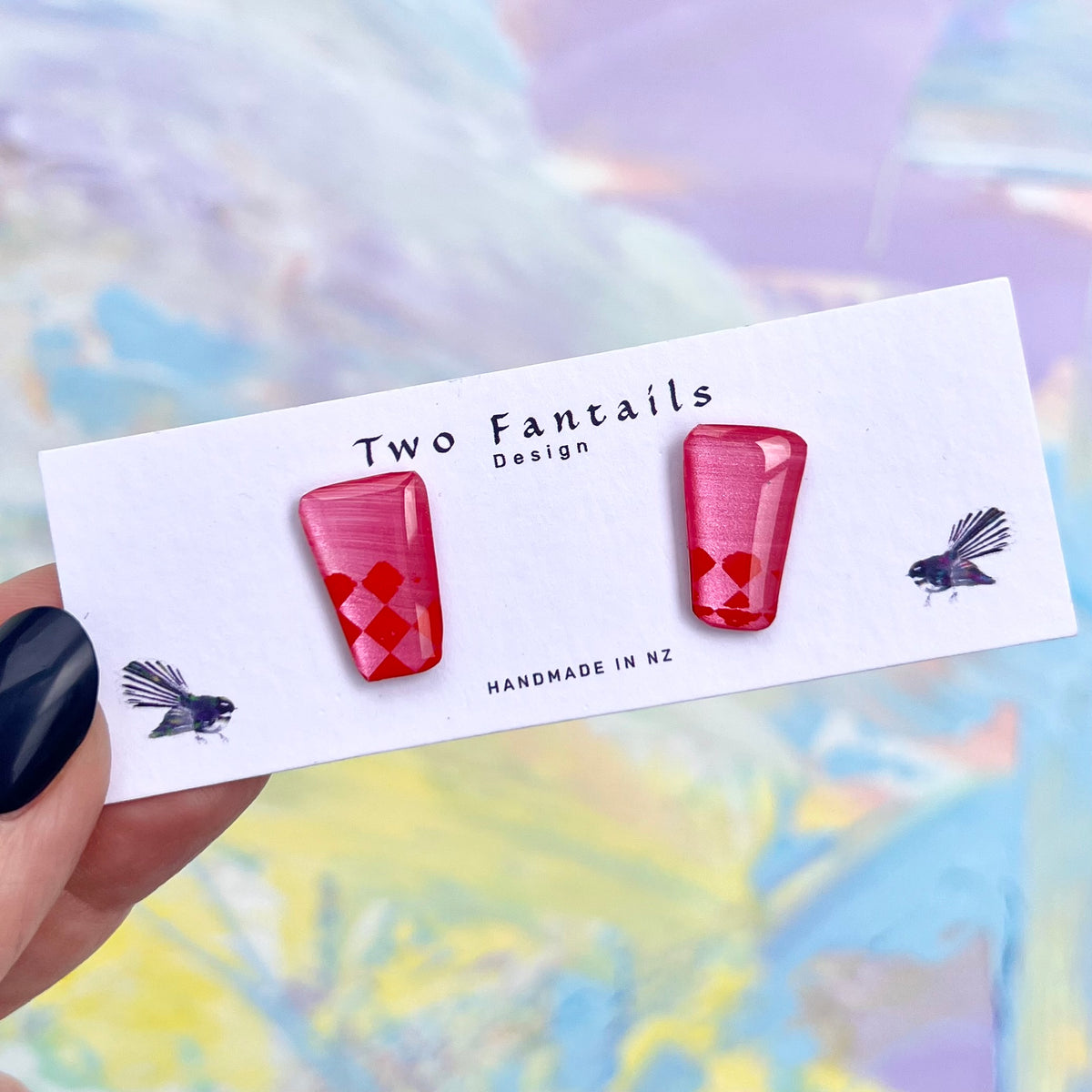 Hand-painted hot pink geometric stud earrings with red checkerboard details