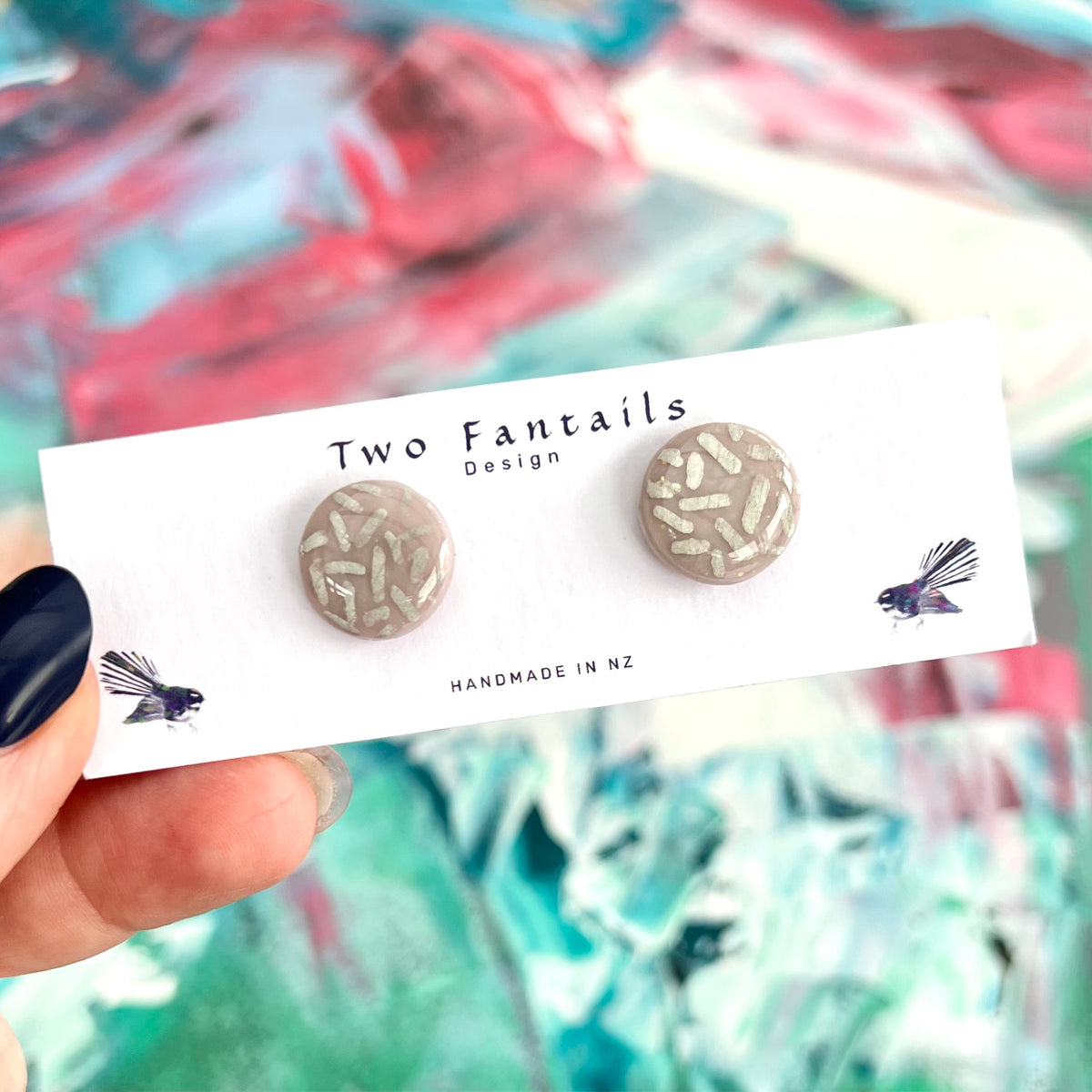 Grey taupe round stud earrings with shimmering silver flecks and glossy resin finish