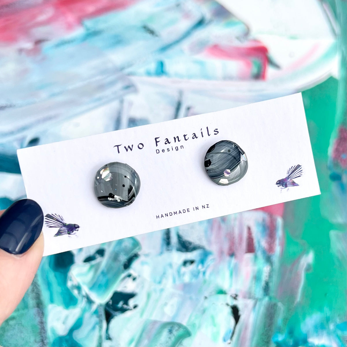 Hand-painted smoky grey and black round stud earrings with silver reflective accents