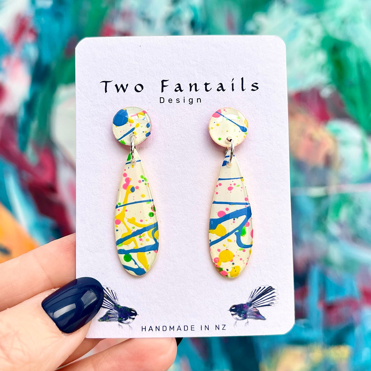 Splash Happy cream abstract long drop earrings with blue yellow pink and green paint splashes